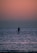 a man standing on a paddle board in the ocean