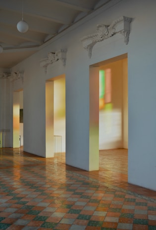 Sunlit hallway with classic molding and polished brass accents reflecting quality and care.