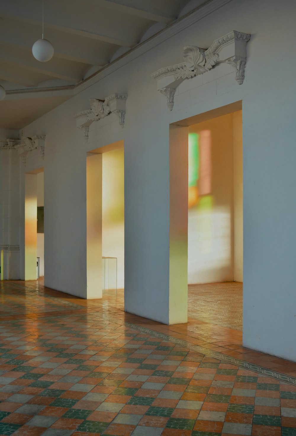 an empty room with three doors and a tiled floor