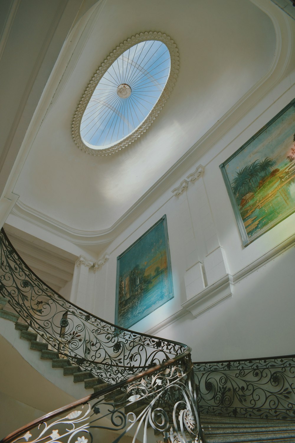 a spiral staircase with a skylight above it