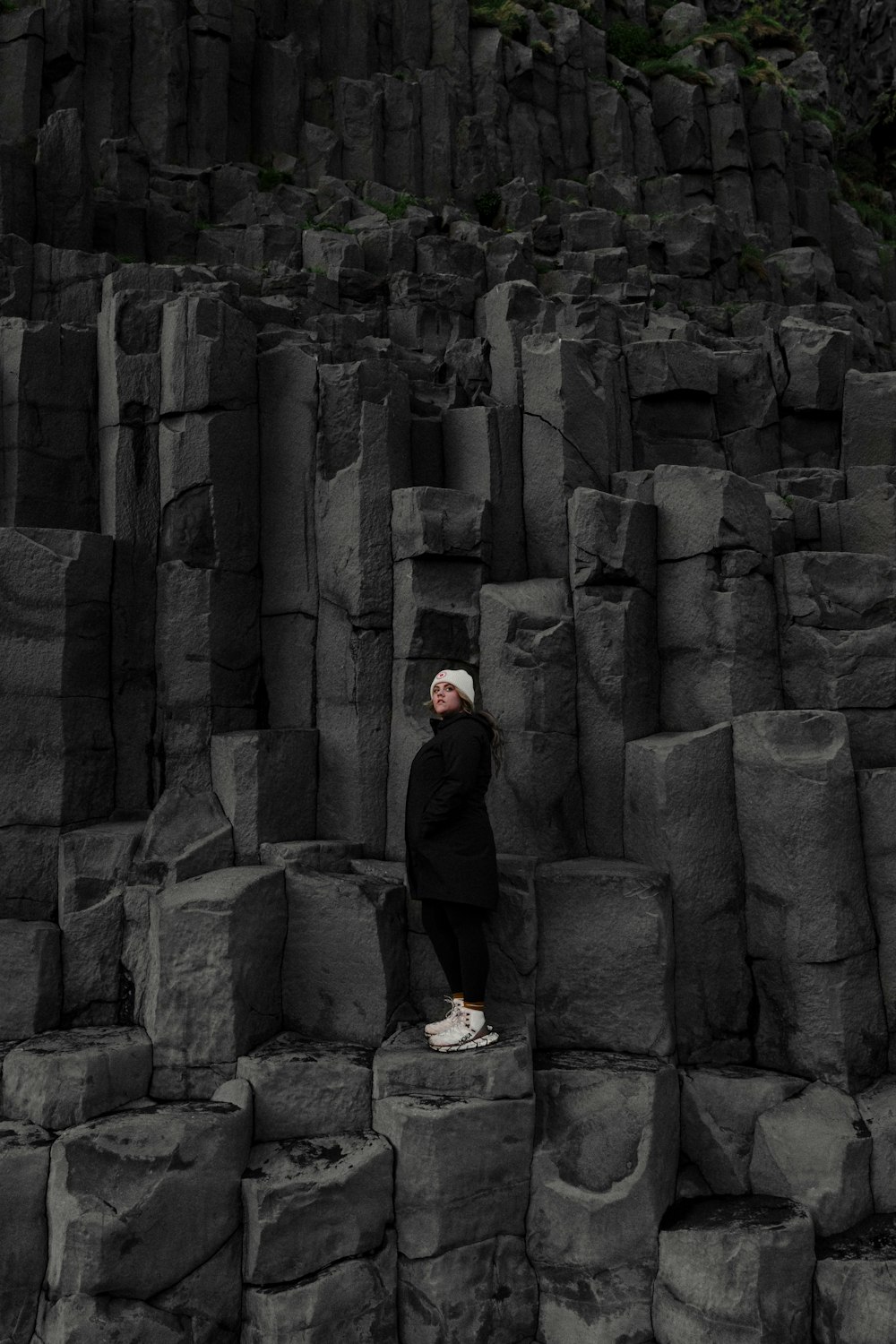 a person standing on top of a large pile of rocks