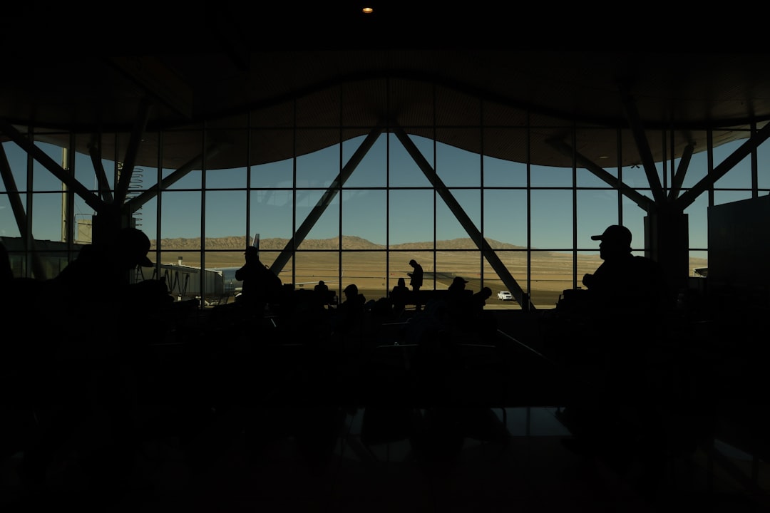 a group of people standing in front of a window,