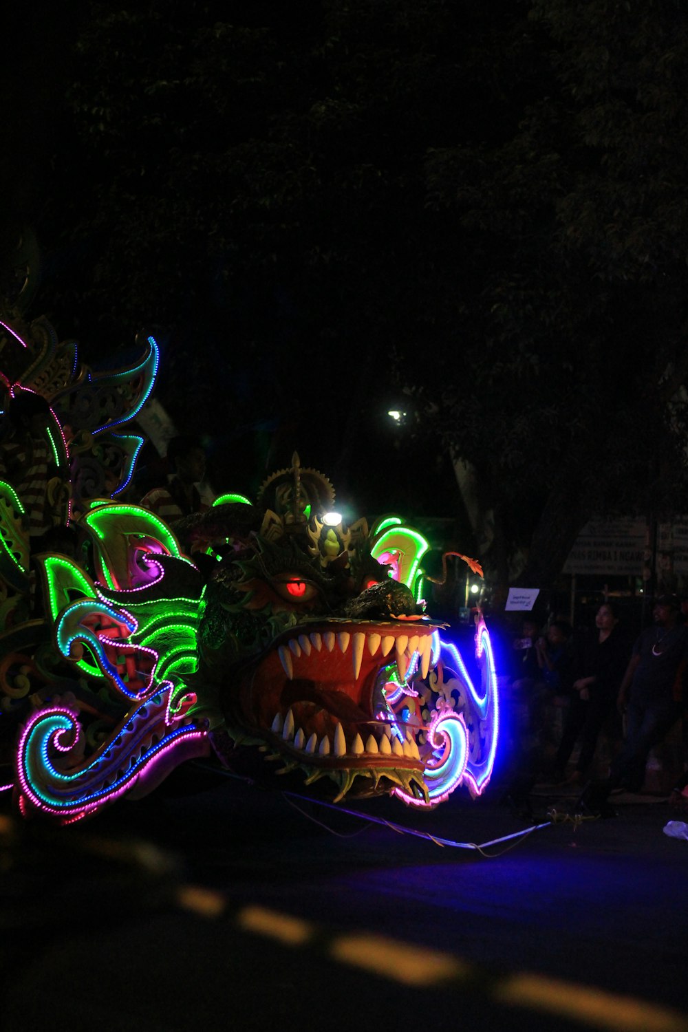 a dragon float is lit up at night