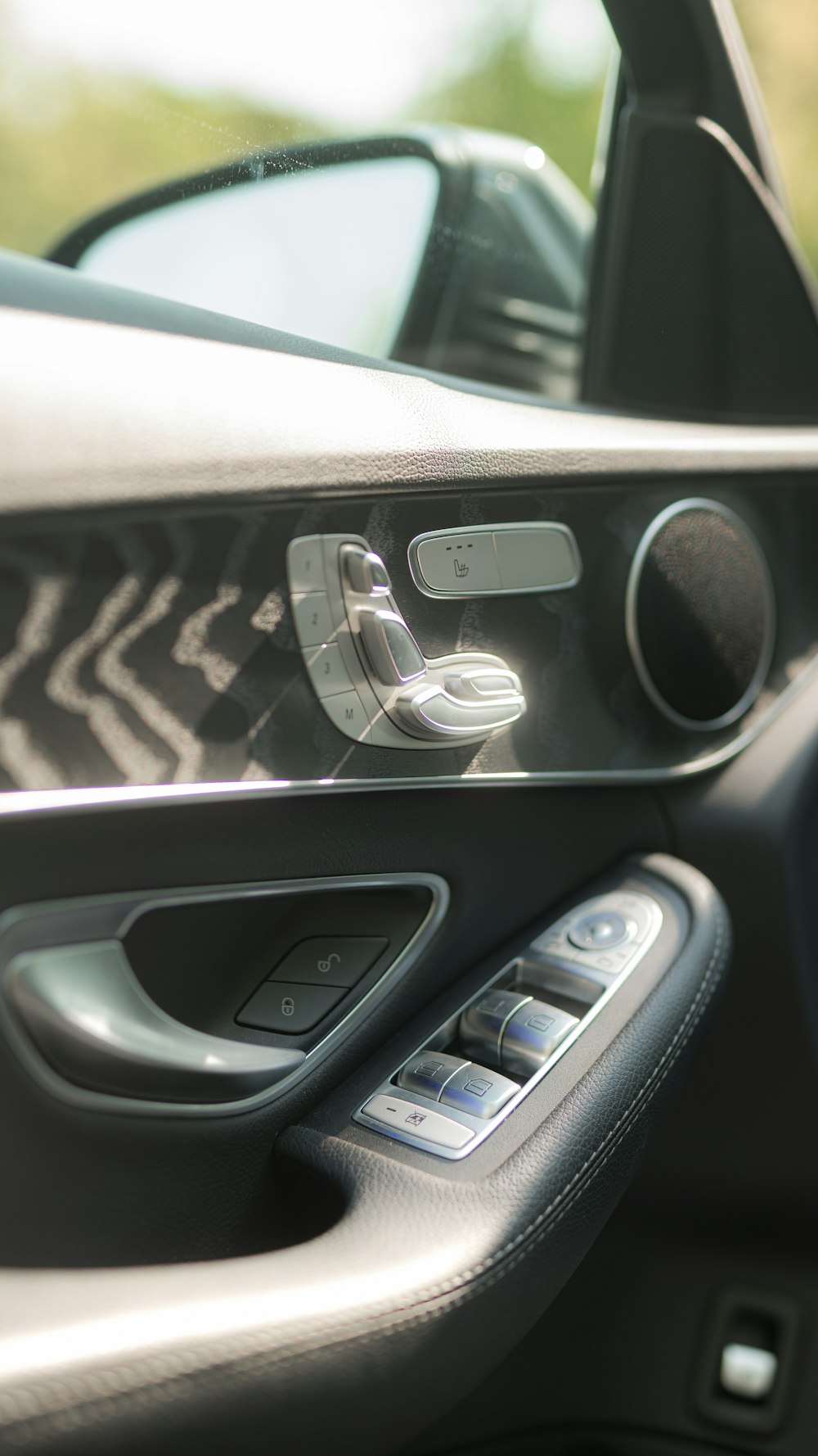 a close up of a car door handle and a mirror