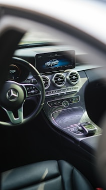Sleek dashboard view of a luxury car interior with a digital inventory screen in the background.