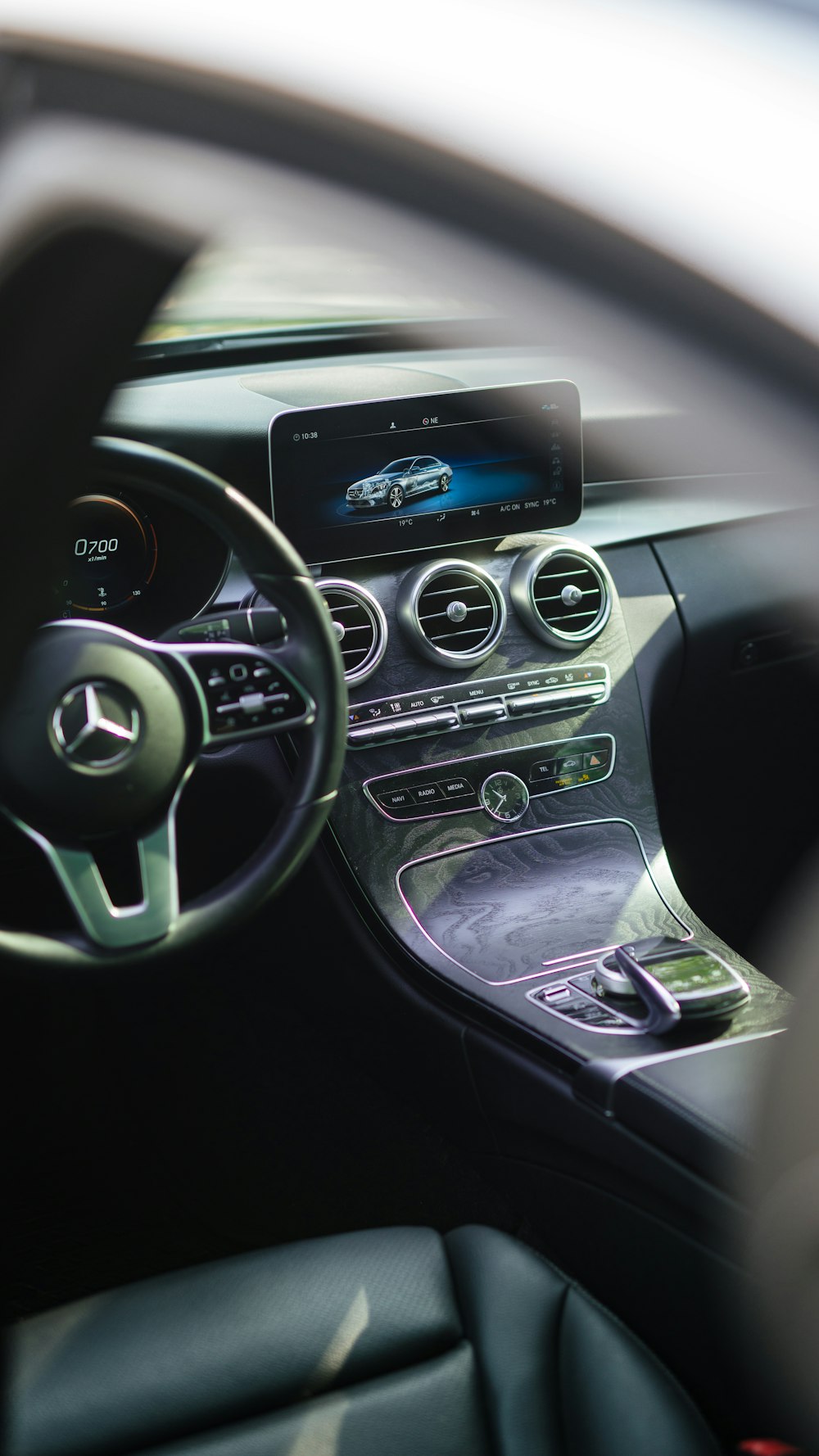 the interior of a car with a steering wheel and dashboard