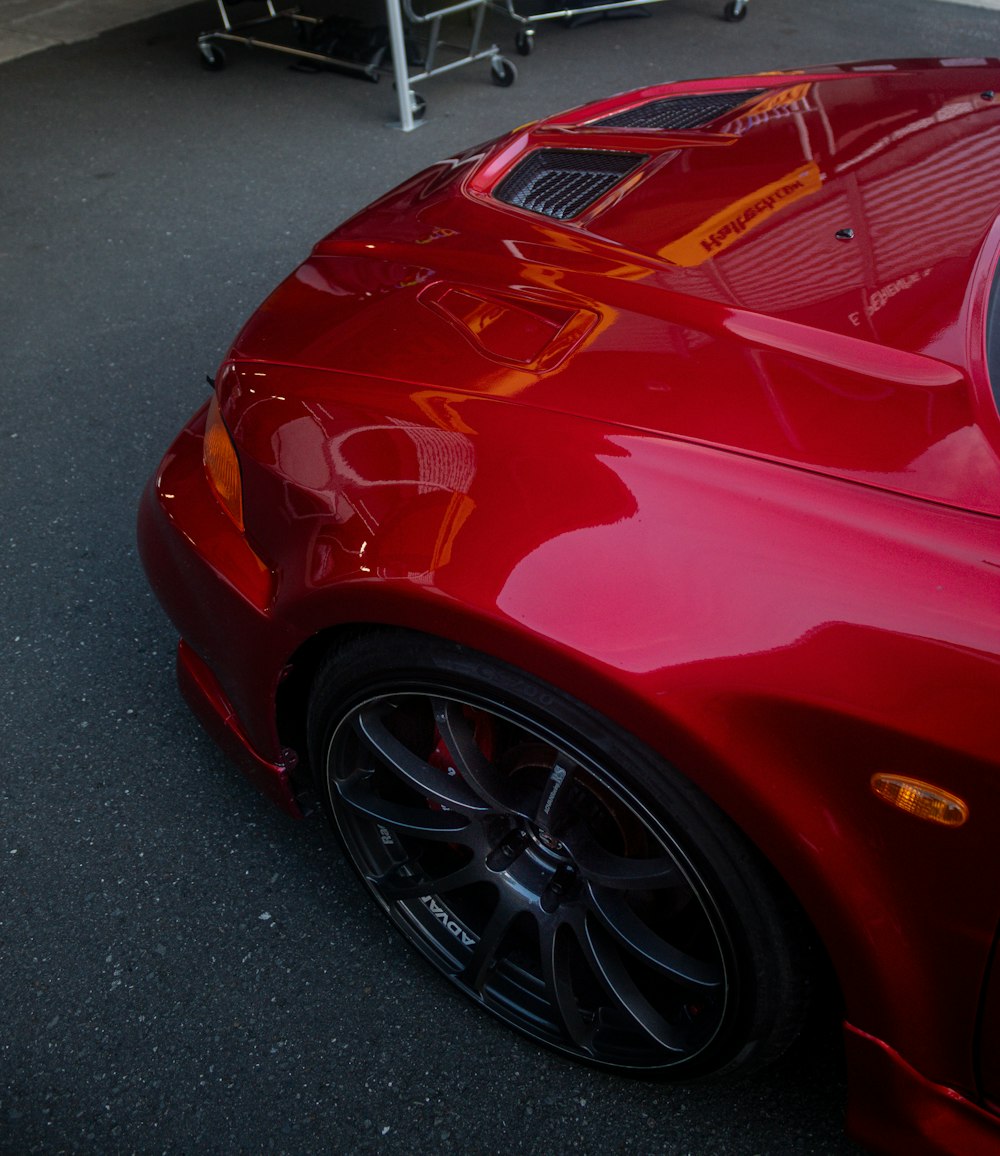 a red sports car parked in a parking lot