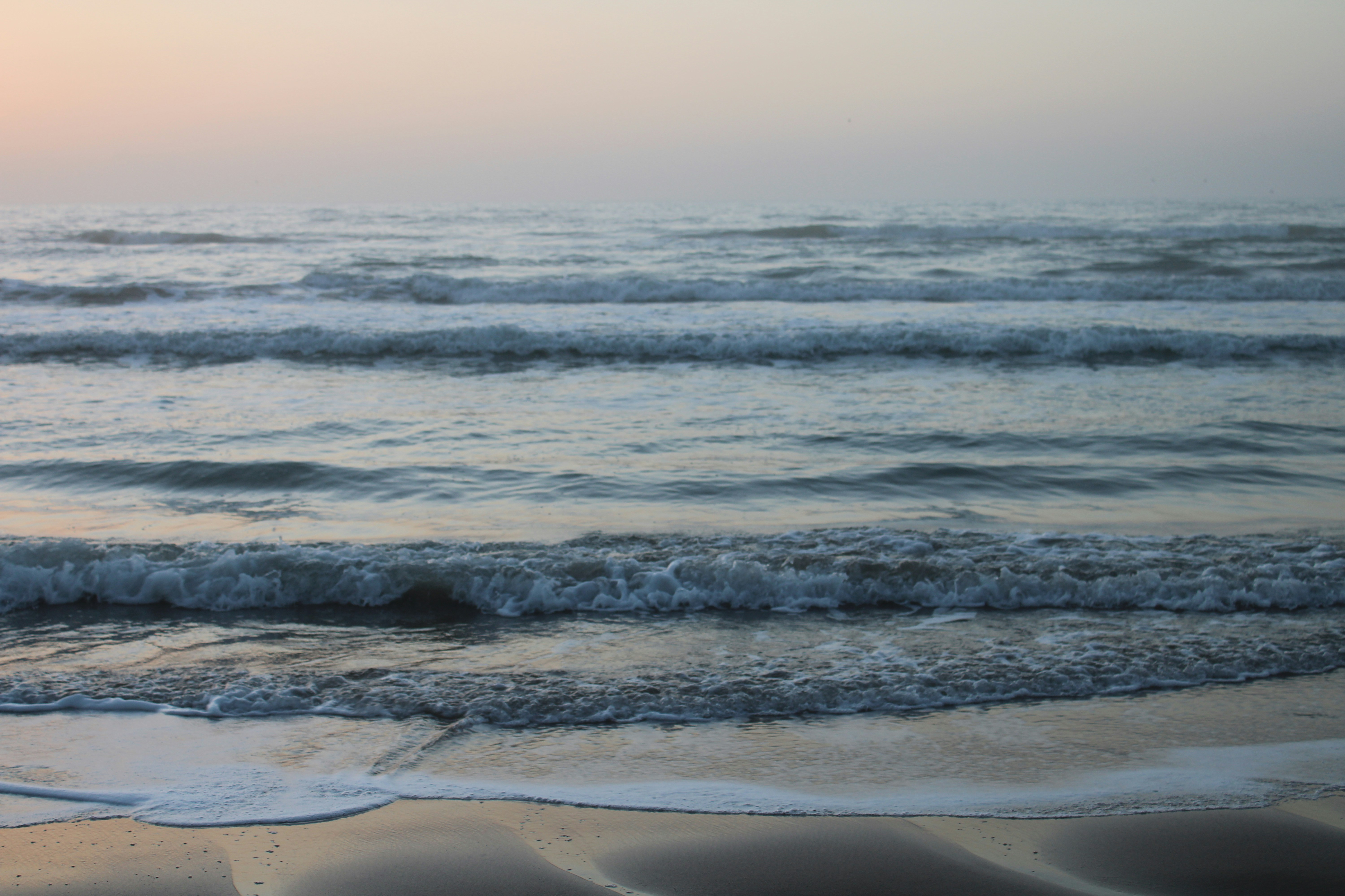 a beach with waves coming in to shore