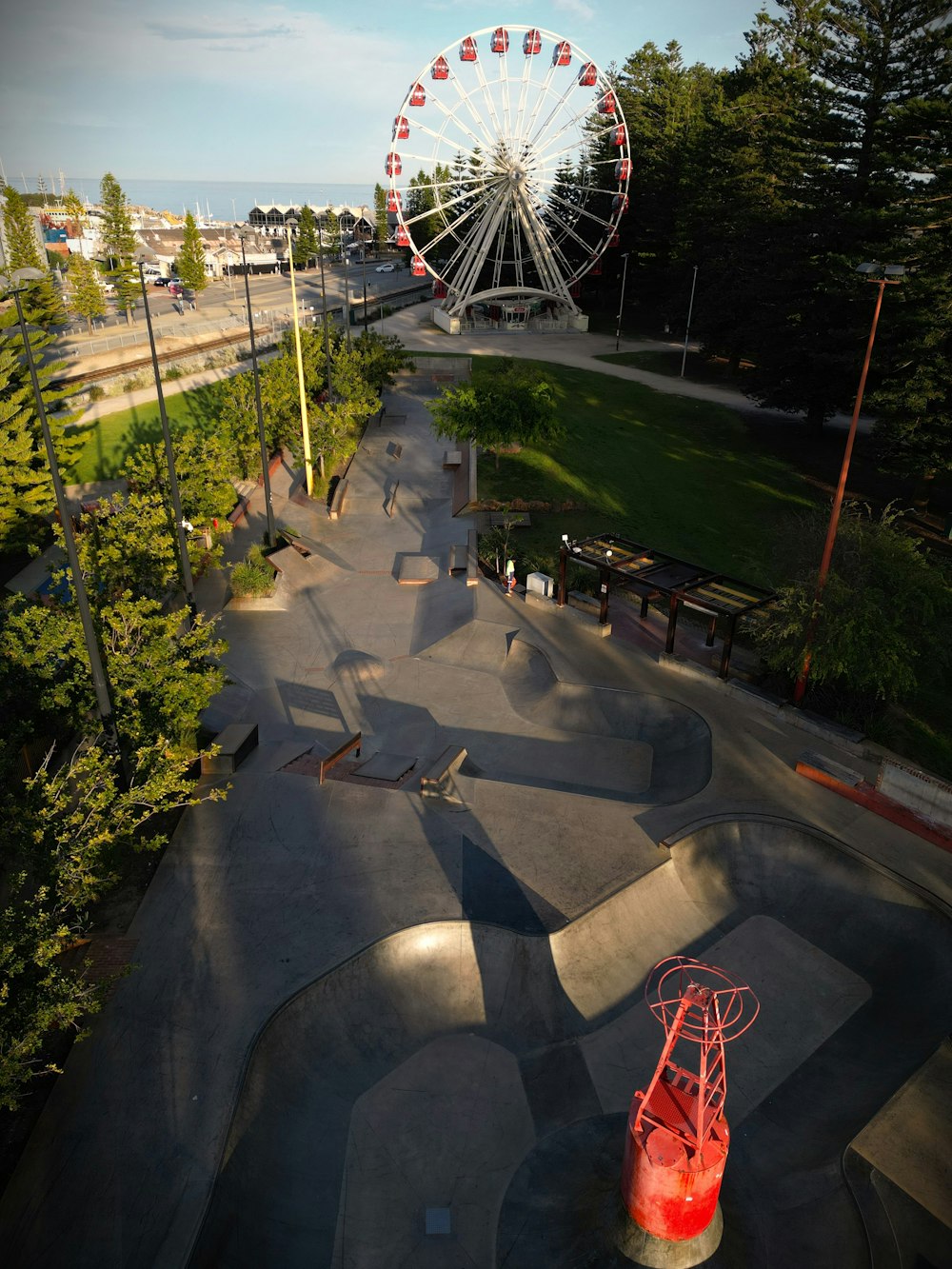 a skateboard park with a ferris wheel in the background