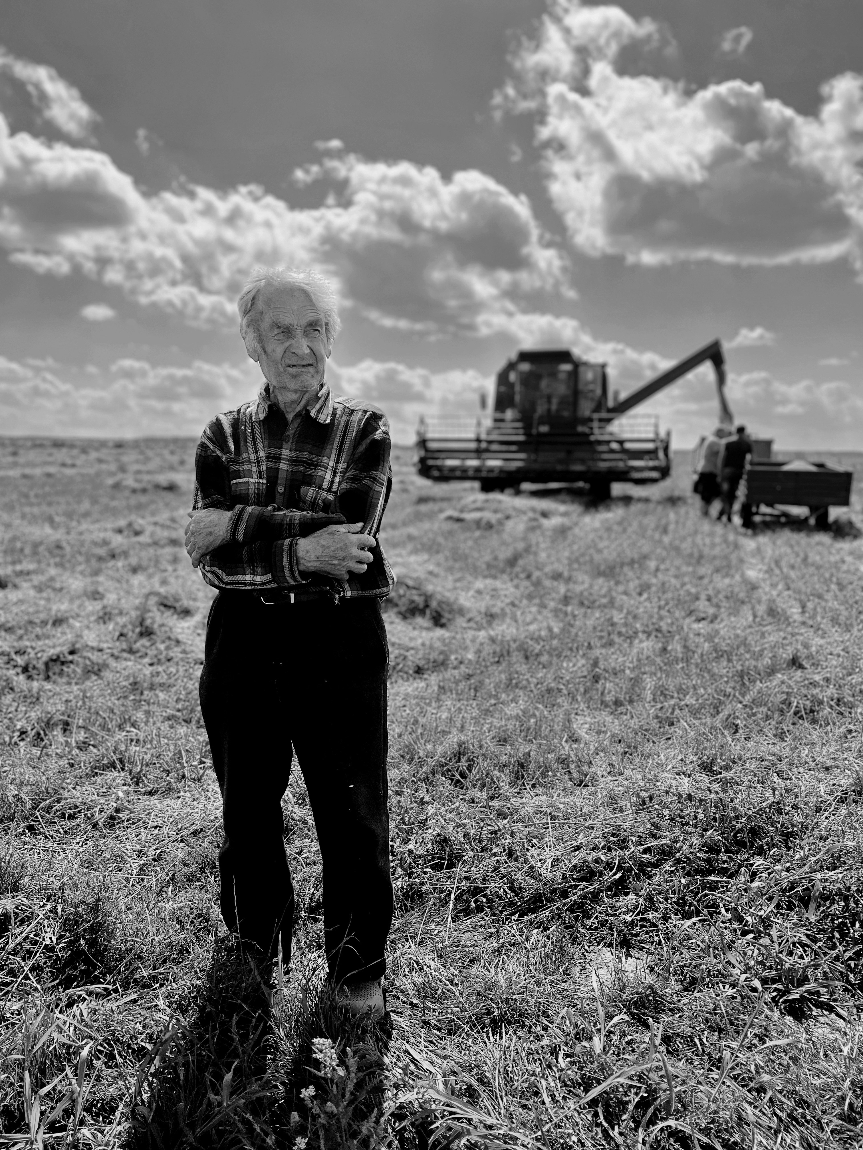 a black and white photo of a man standing in a field