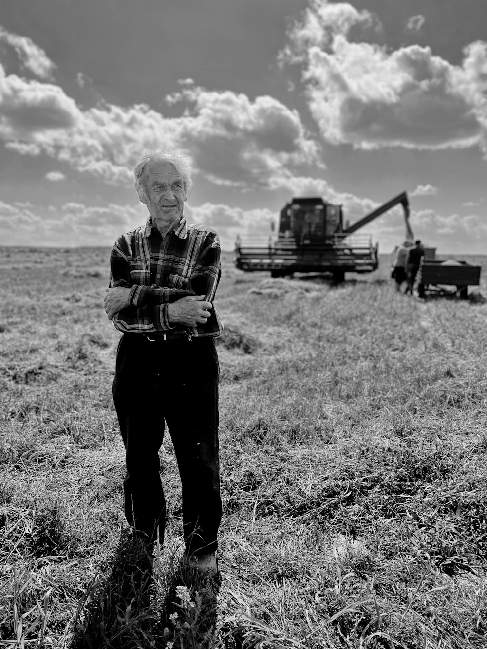 a black and white photo of a man standing in a field