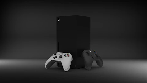two video game controllers sitting next to each other
