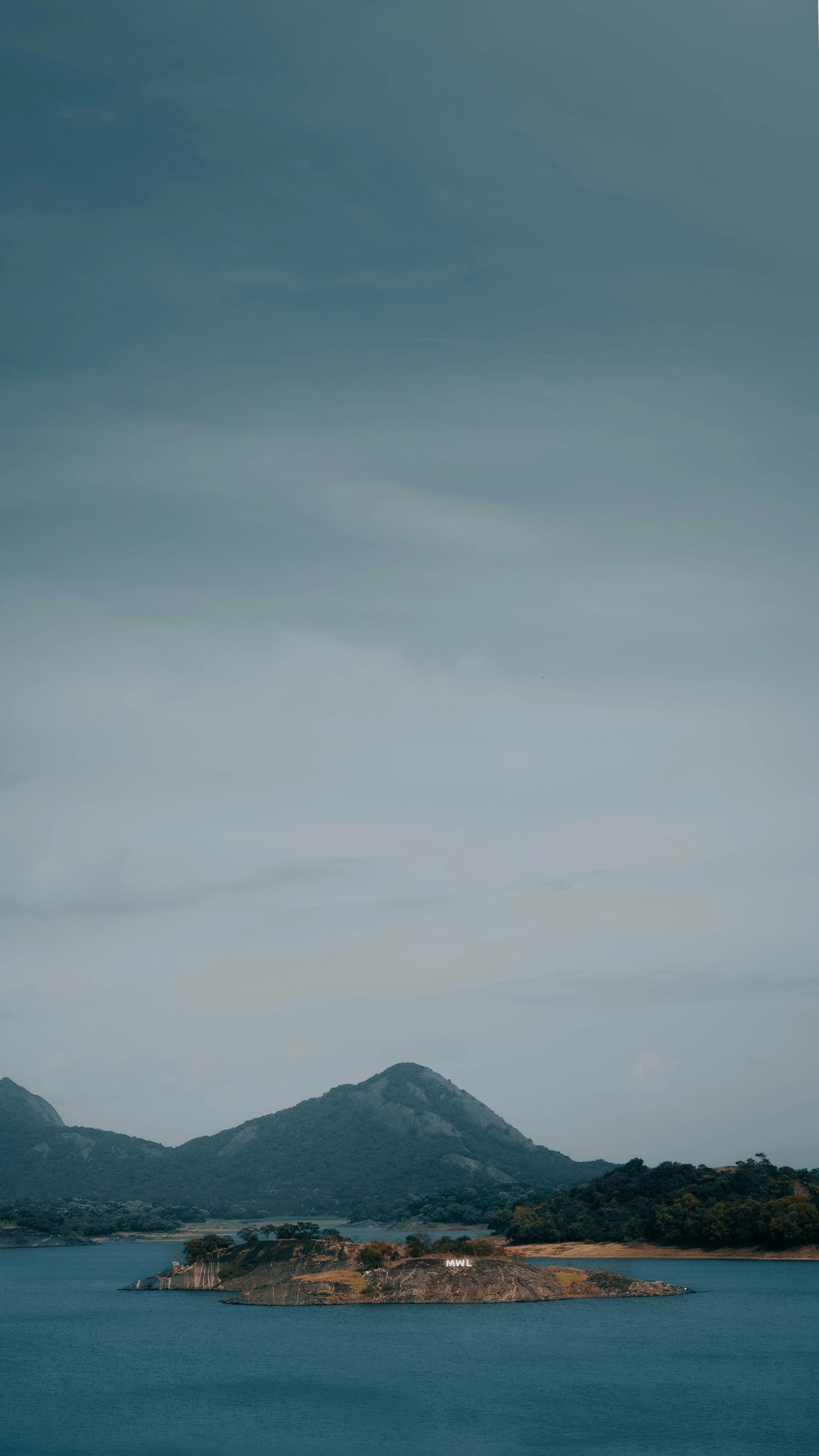 a body of water with a small island in the middle of it