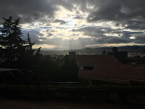 Sunlight filtering through the iconic Cerro de la Silla mountain over the city skyline