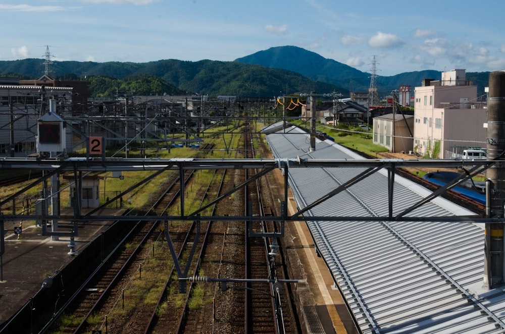 a view of a train station with a mountain in the background