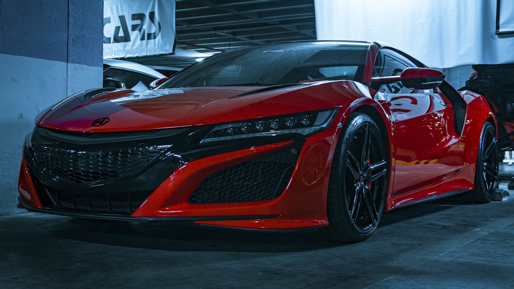 a red sports car parked in a garage