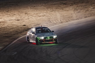 Dynamic shot of a Stock Car speeding through a curved racetrack under dramatic lighting.