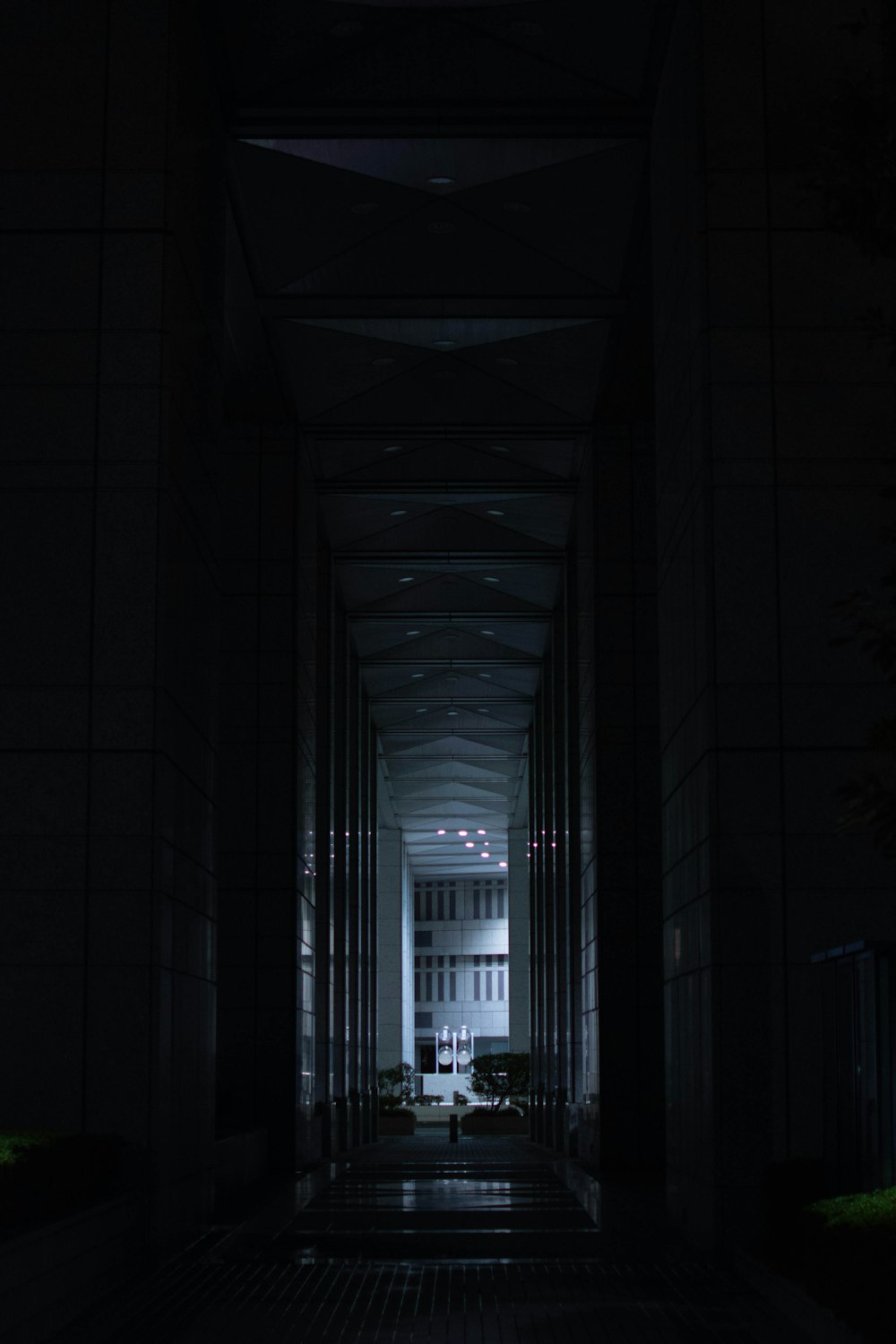 a dark hallway leading to a large building