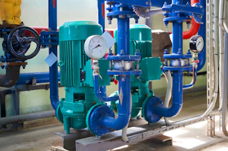 a group of pipes and valves in a room