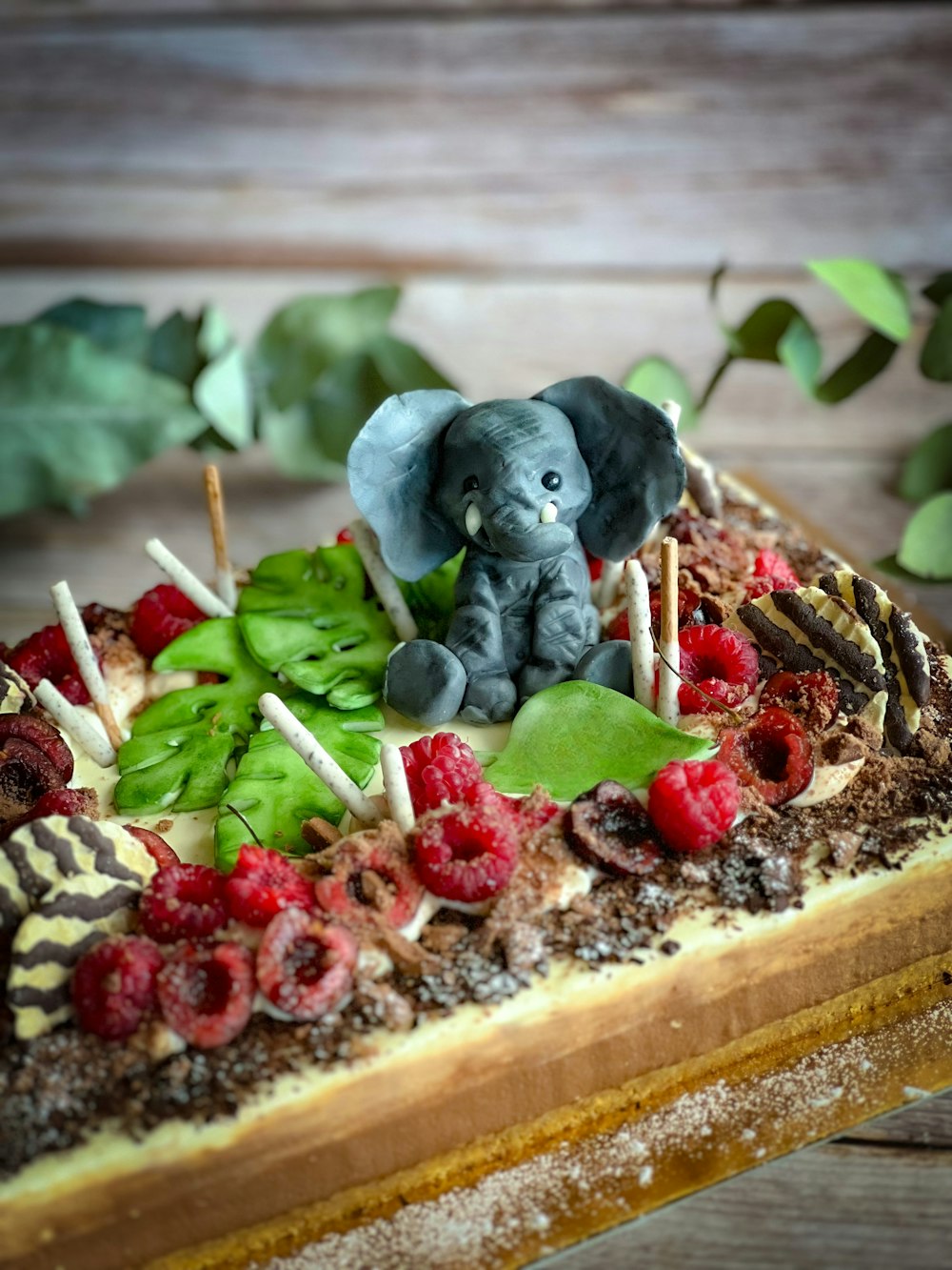 a cake with a small elephant on top of it