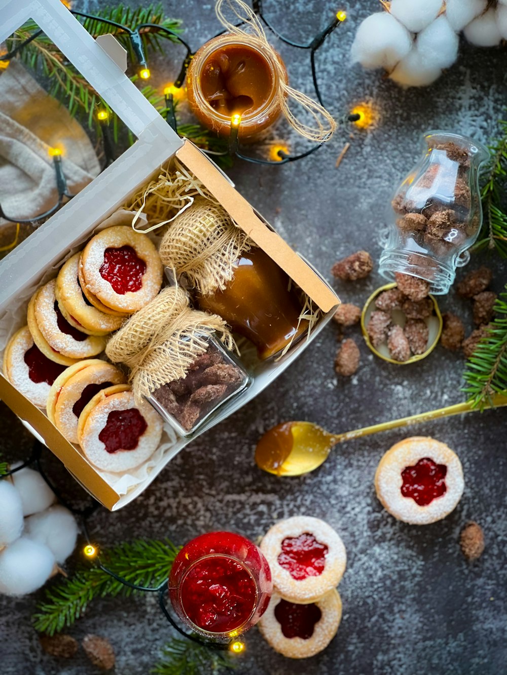 a box filled with cookies next to a christmas tree