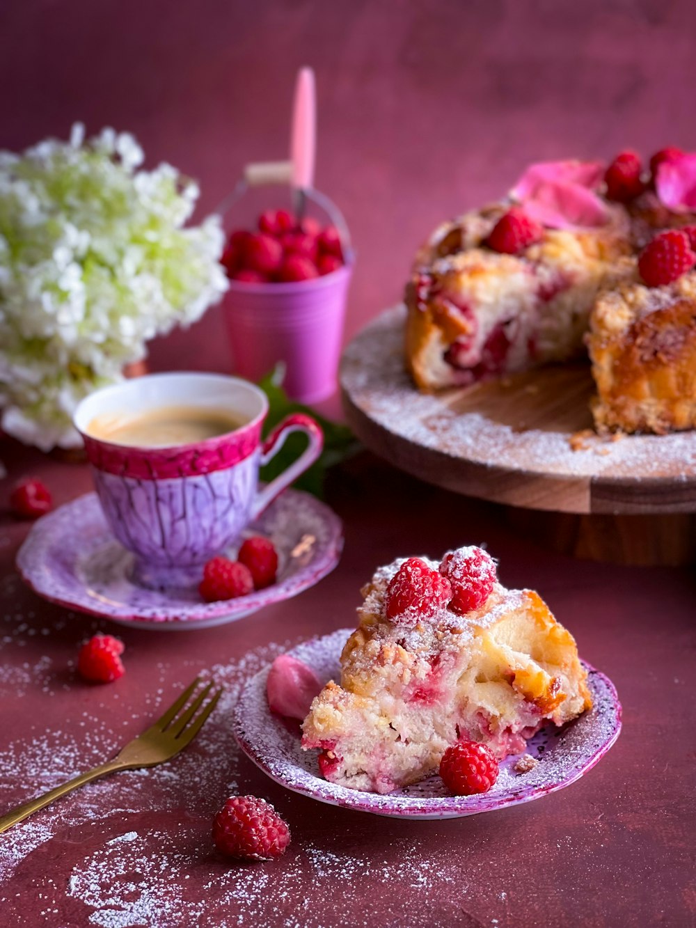 a piece of cake on a plate next to a cup of coffee