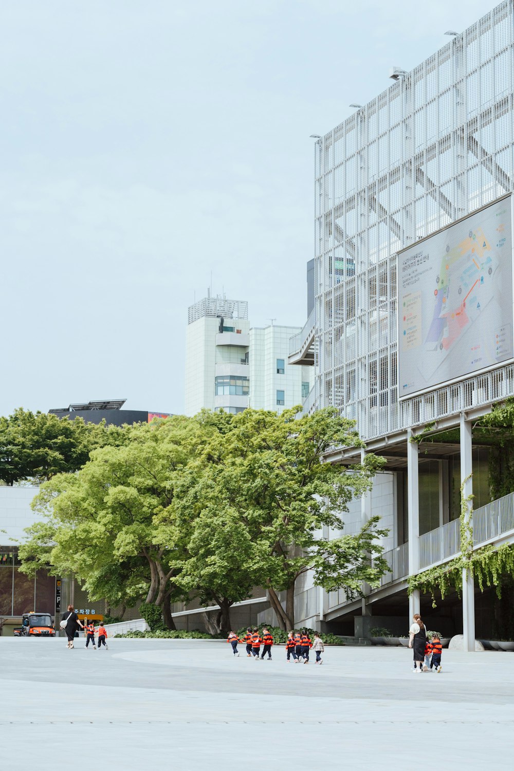 a group of people walking in front of a building