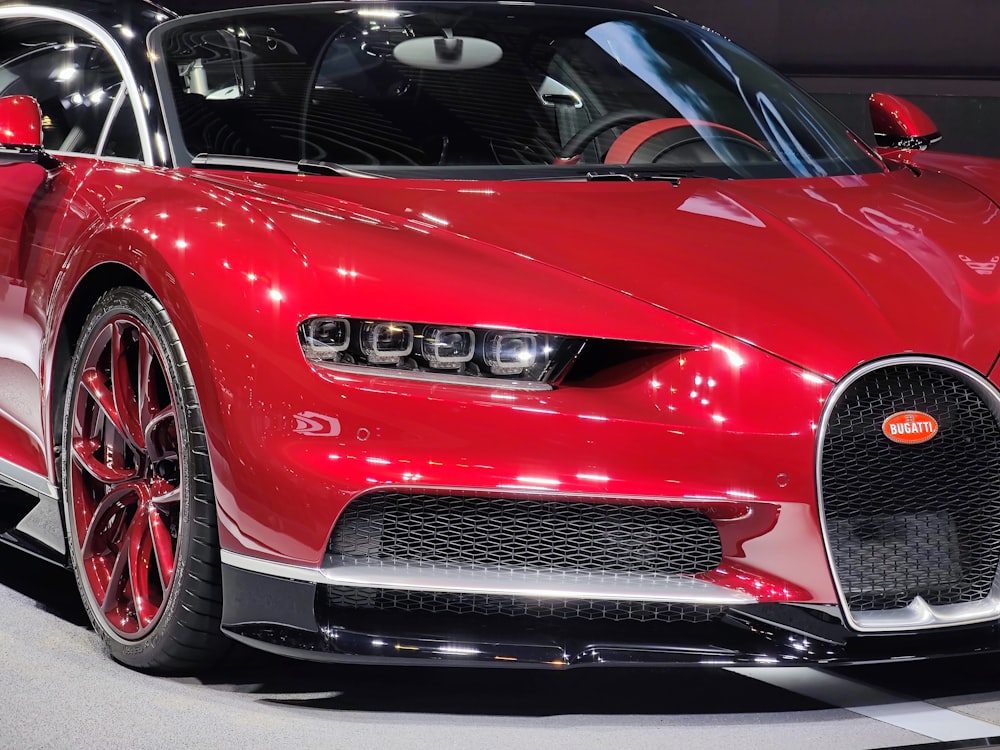 a red bugatti is on display at a car show