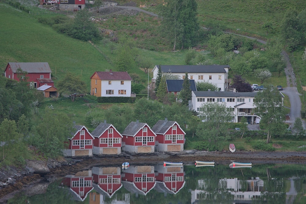 a group of houses sitting on top of a lush green hillside