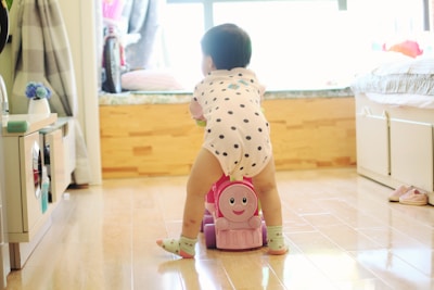 a toddler playing with a toy on the floor