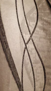 Close-up of charcoal textured layout with subtle gold lines.