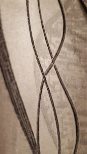 Elegant golden lines forming a subtle architectural structure on a deep charcoal background.