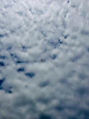 An airplane flying over the clouds, symbolizing air travel.