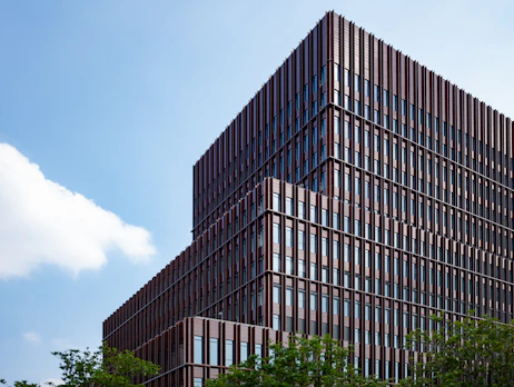 Modern office building with emerald green and gold accents reflecting a premium spice export company.
