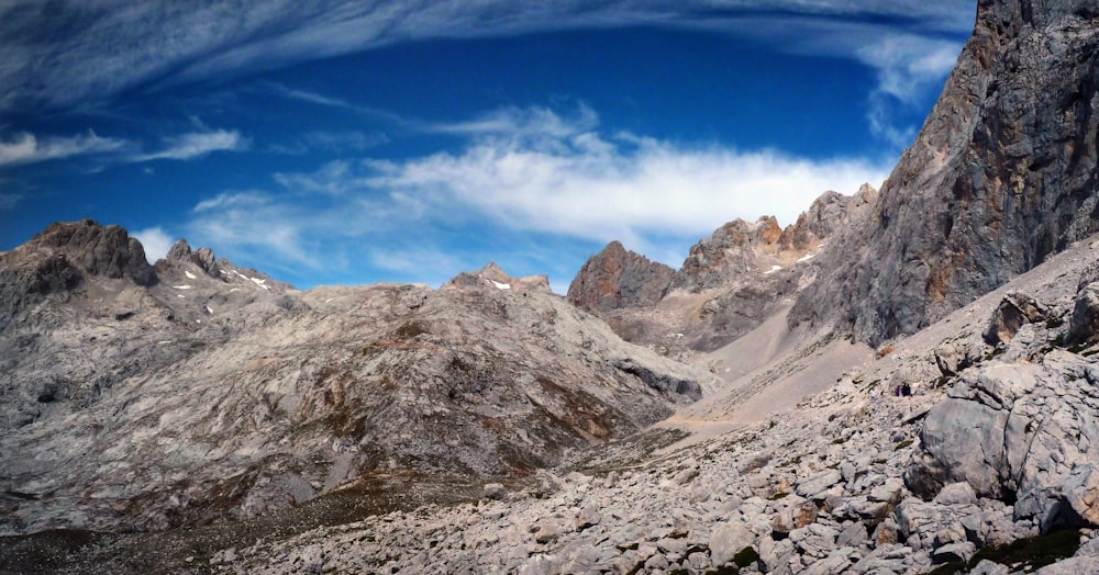 a group of people hiking up a rocky mountain