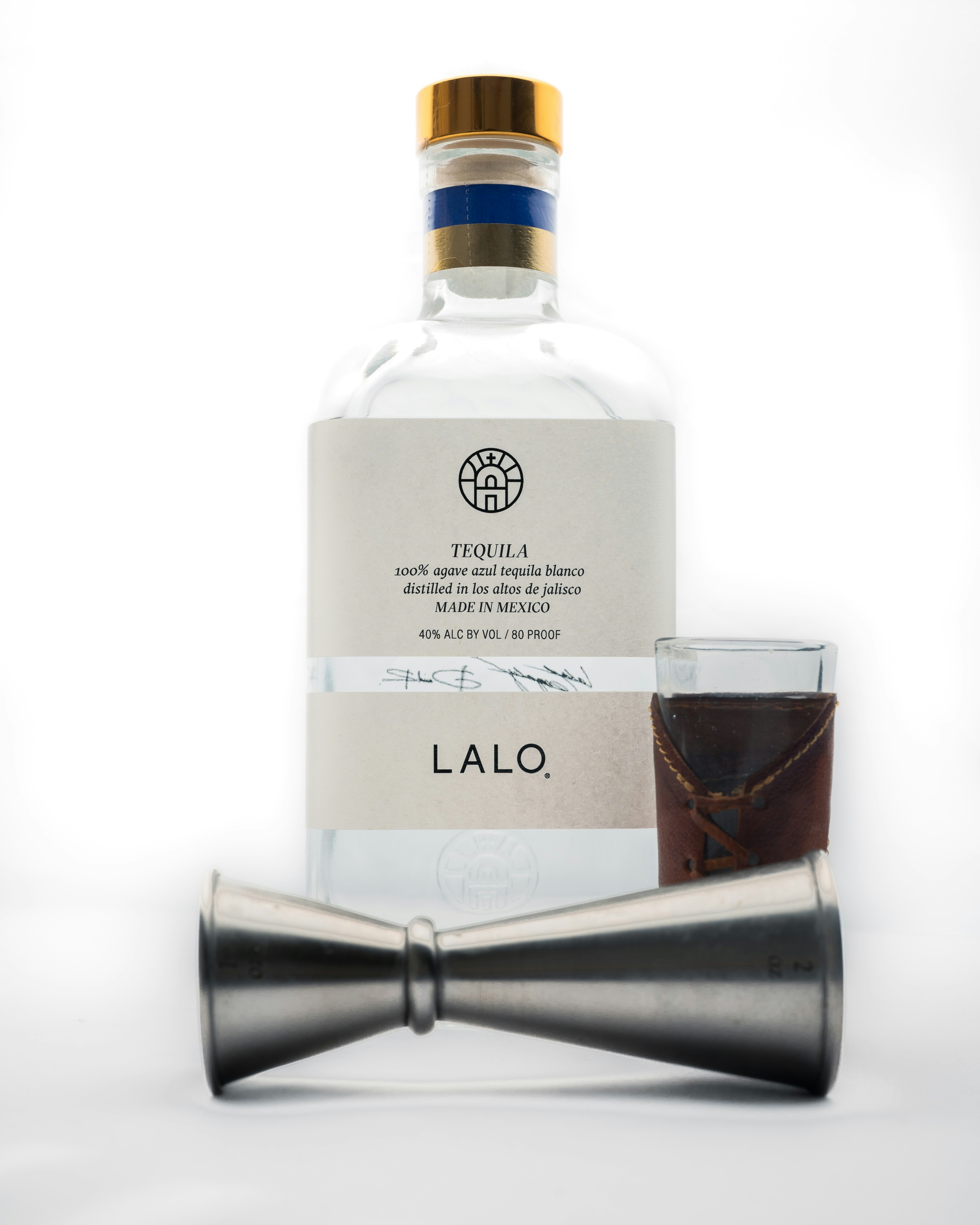 a bottle of alcohol next to a bow tie