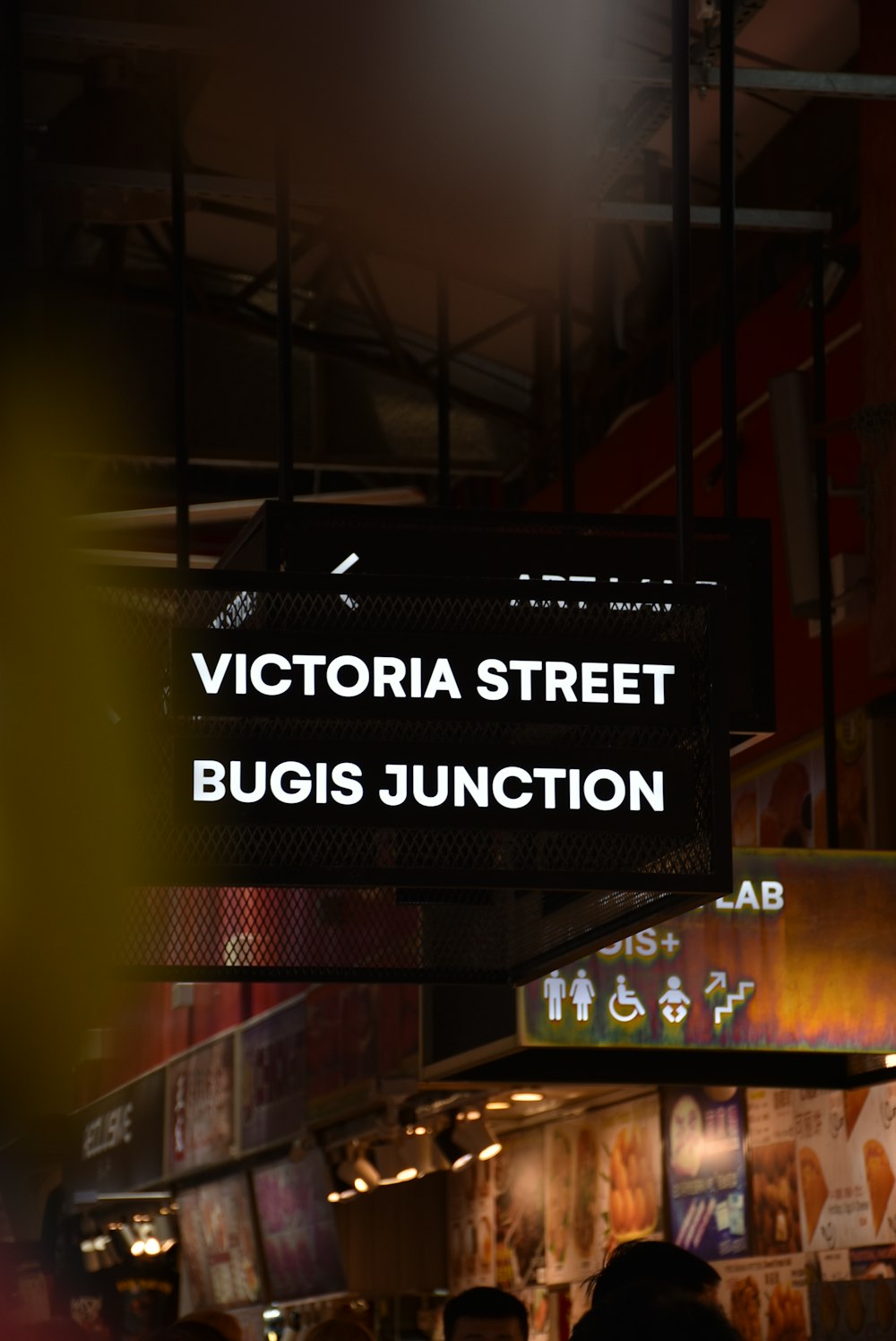 a sign that says victoria street bugis junction