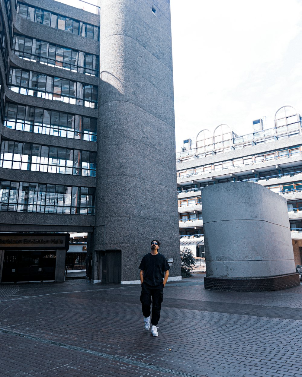 a man standing in front of a tall building