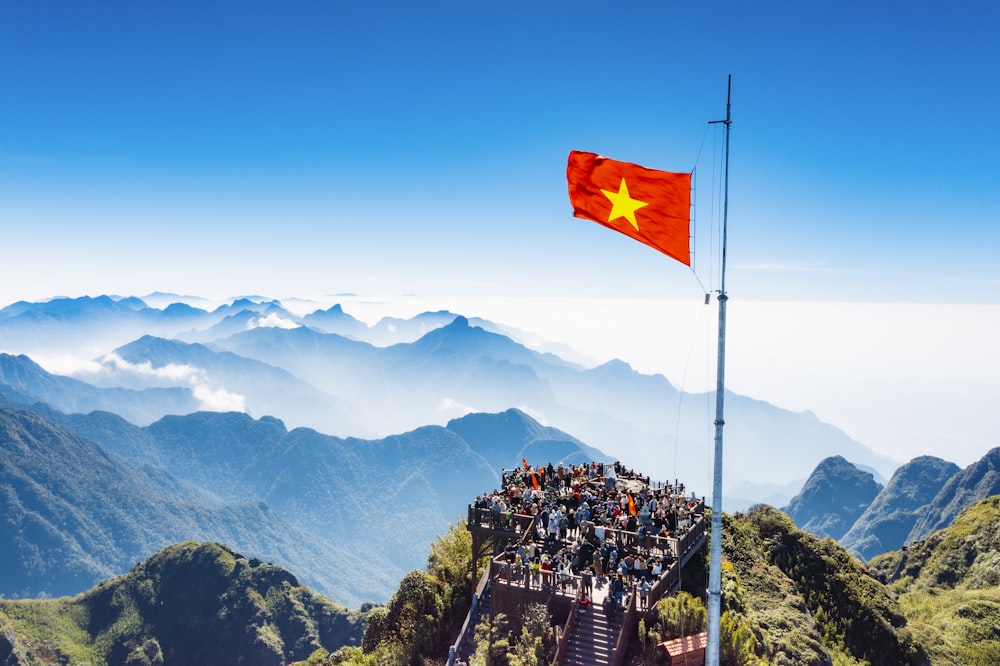 a large group of people standing on top of a mountain