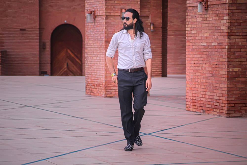 a man in a white shirt and black pants