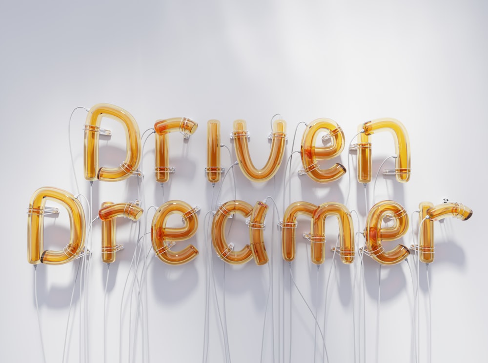 a group of balloons that say driven dreamer