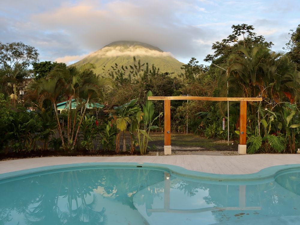 a swimming pool with a mountain in the background