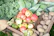 Close-up of vibrant organic fruits and vegetables arranged in rustic wooden crates.