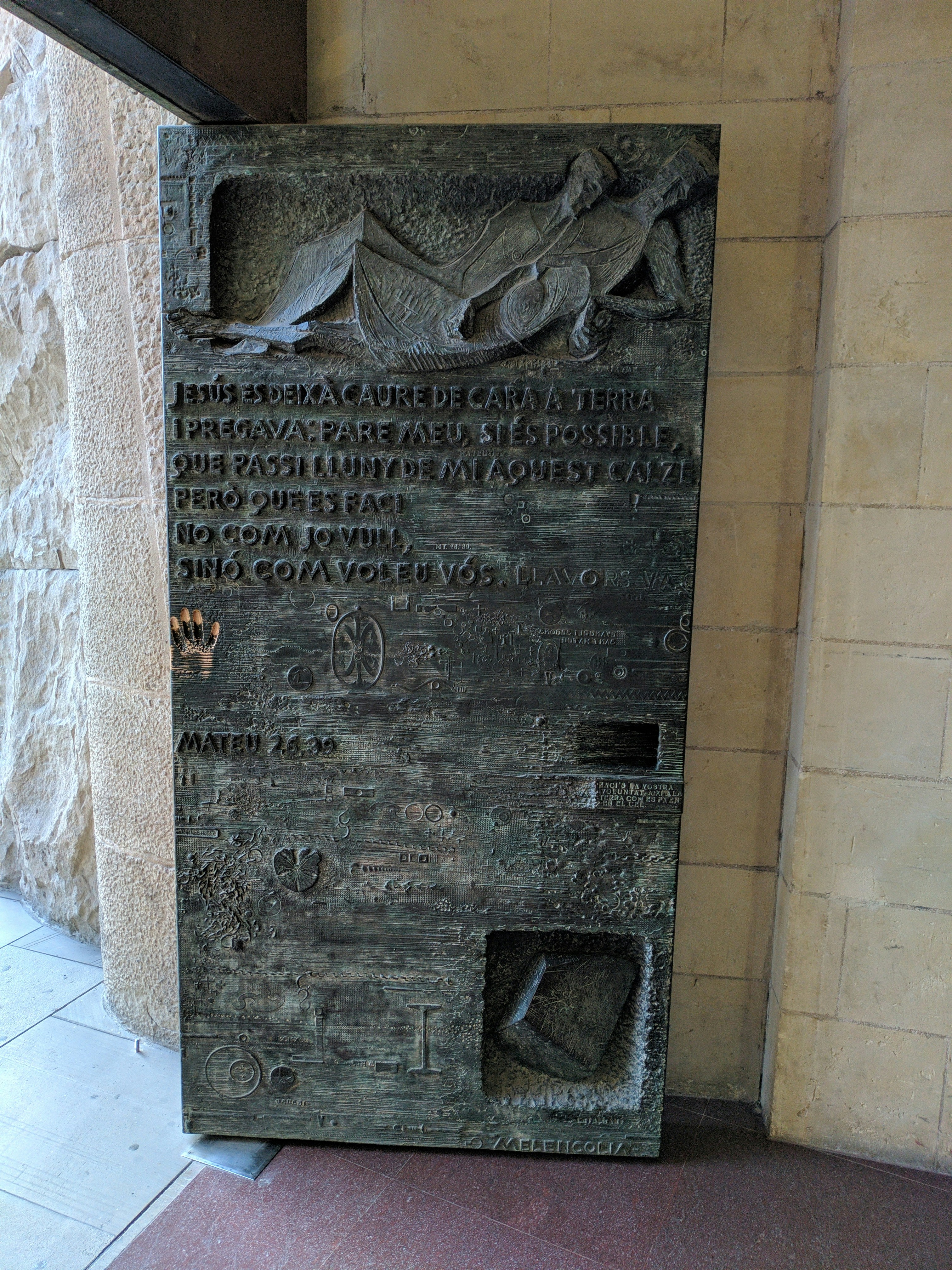 a statue of a man laying down on a bench