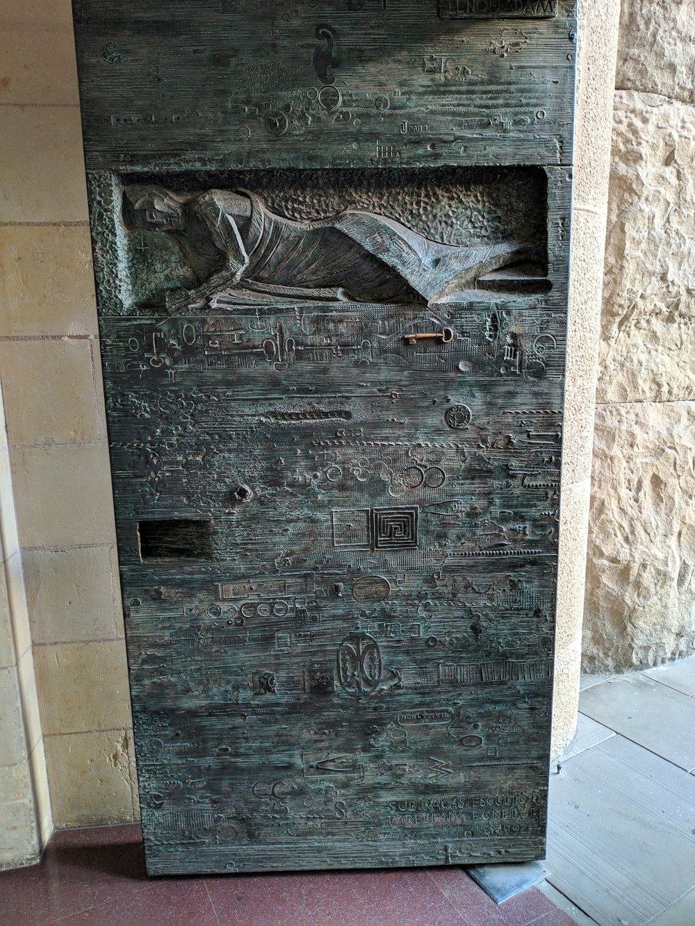 a wooden door with a carving of a bird on it