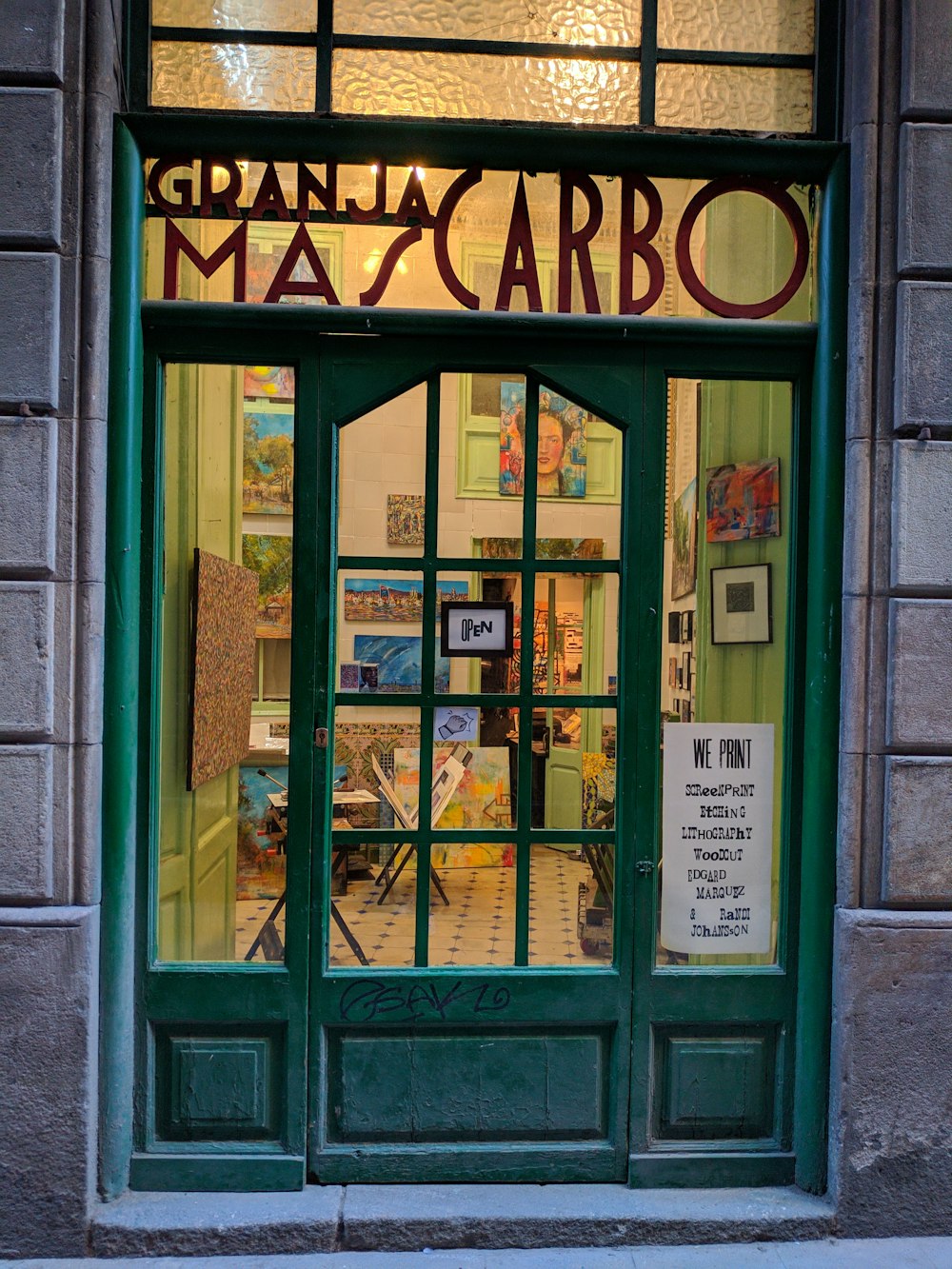 a store front with a green door and window