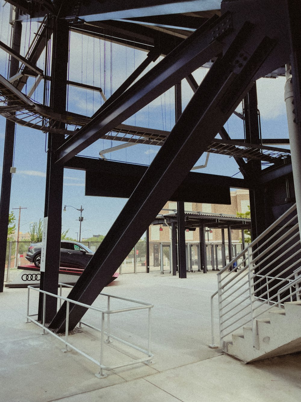 a car is parked under a metal structure