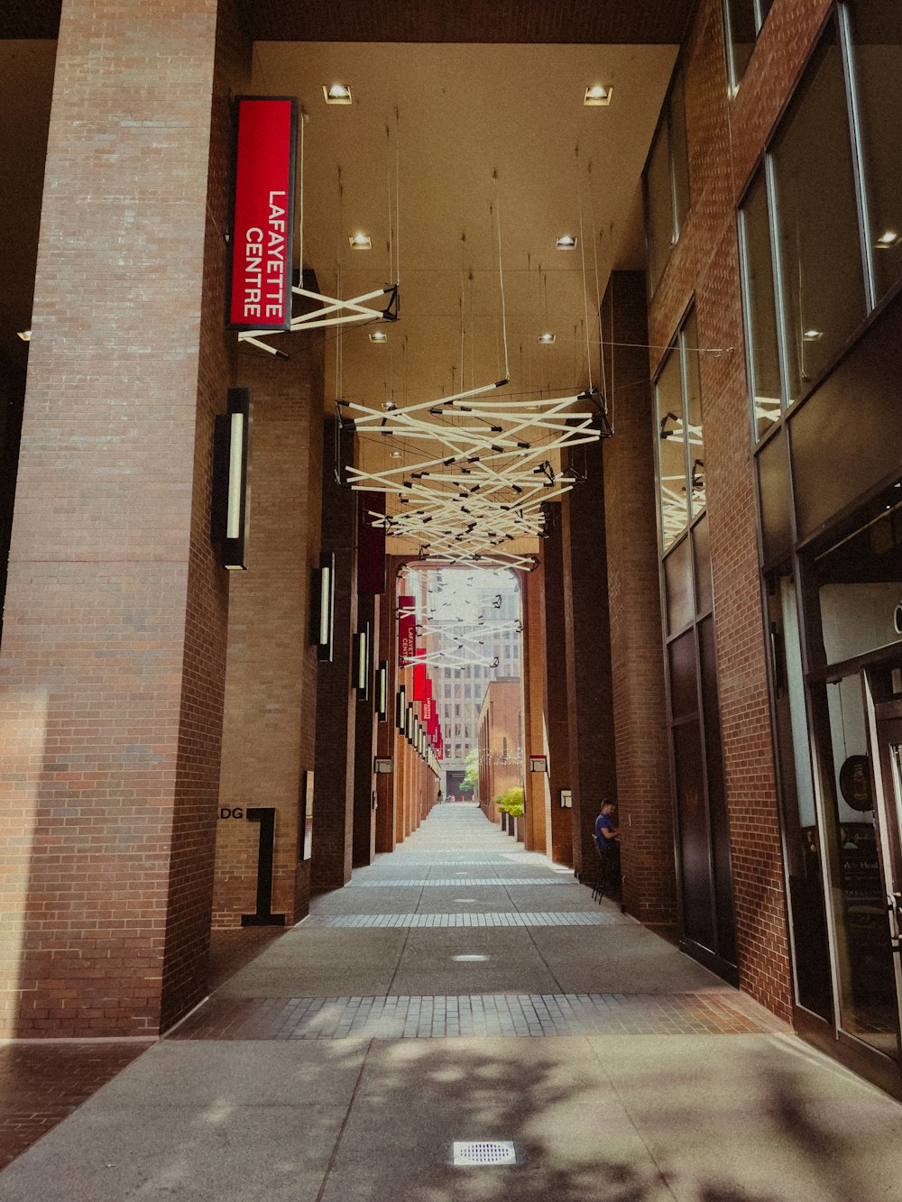 a long hallway with a red sign hanging from the ceiling