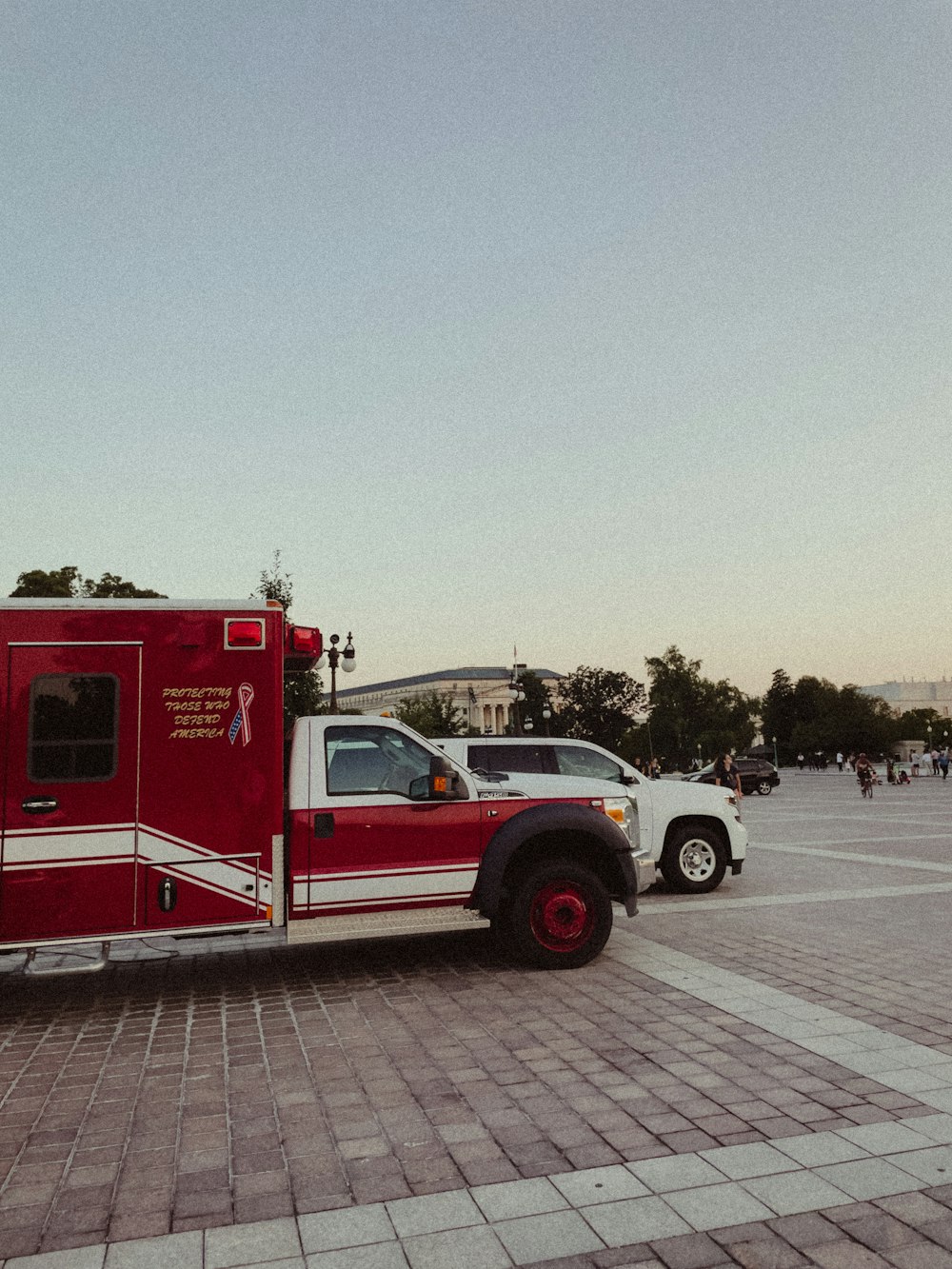 a red and white fire truck parked in a parking lot