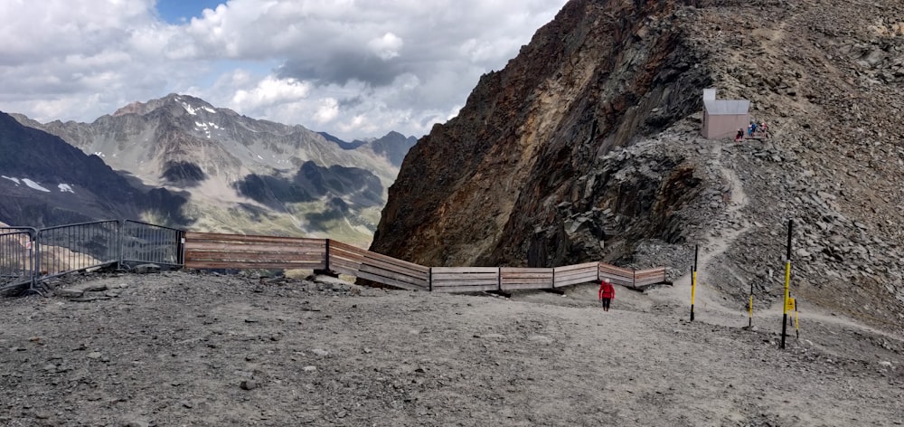 a person standing on a mountain with a basketball hoop